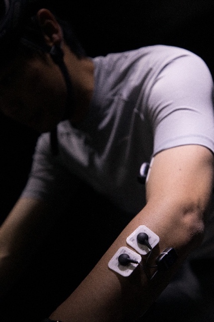 Surface EMG electrodes measuring upper-limb muscle activation.